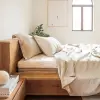 Bettlaken aus naturfarbenem Leinen, über ein Bett an einem hellen Fenster gelegt