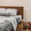 Manta de lino francés Sensoire marfil sobre ropa de cama de lino gris suave